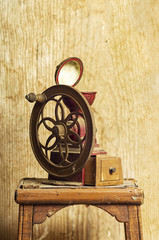 old vintage manual coffee grinder on wooden background