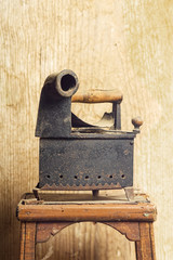 old clothes charcoal iron on wooden background