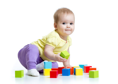 kid playing wooden toy blocks isolated