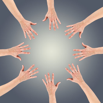 Group of eight hands at the circle together teamwork showing you