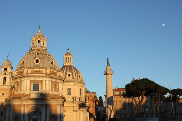 Fototapeta na wymiar view at sunset time of the Trajan column and the Santa Maria di Loreto Church in Rome, Italy
