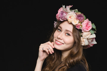 Portrait of beautiful happy young woman in flower wreath