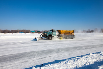 Snowplow is cleaning a road