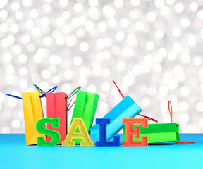 Sale written by colorful letters on the background of shopping b