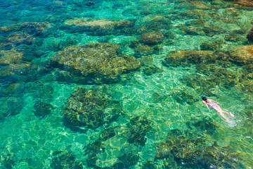 Obraz premium Woman snorkeling in clear sea