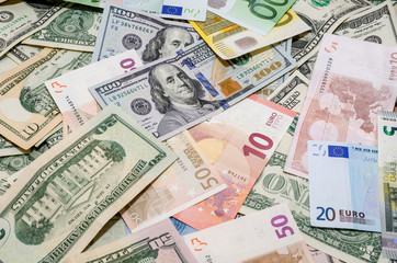 Fototapeta na wymiar Pile of two leading currencies - US Dollar versus Euro as background