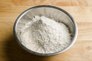Flour in the bowl on wooden background,food ingredient