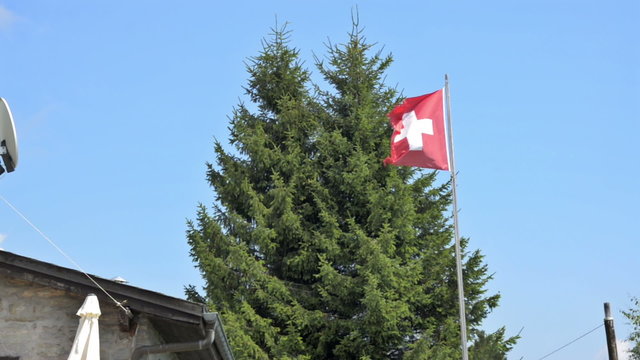 Swiss flag flapping in the summer sun. 
