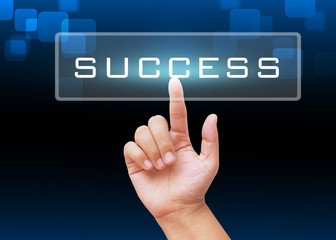 Hand pressing success button with technology background 