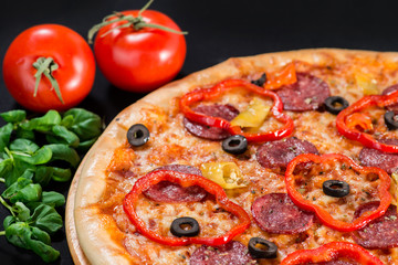closeup Tasty pizza with tomatoes, mushroom, sausage, basil and