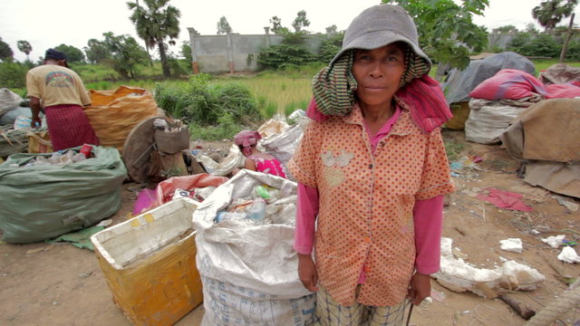 Garbage gatherers assorting trashes in slums