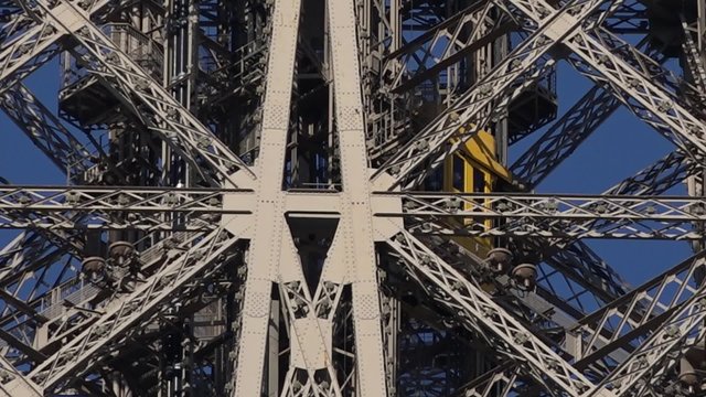 Follow elevator Eiffel tower with tourists - 60fps. Camera follows elevator of the Eiffel Tower until the 1st floor with tourists - Full HD