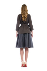 girl in a jacket and skirt from behind isolated