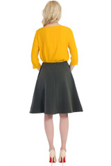 woman in a blouse and skirt back isolated on white