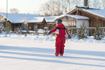 Fototapeta na wymiar Happy child skating in winter at the rink