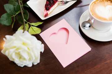 close up of greeting card with heart and coffee