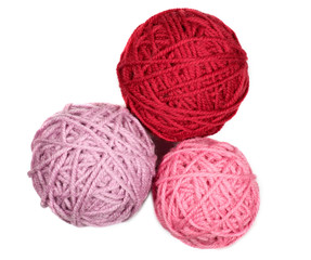 Three skeins in pink and red tones over white