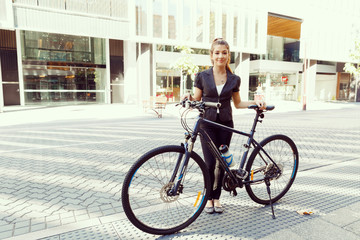 Fototapeta premium Young woman commuting on bicycle