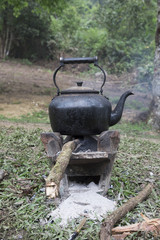 Old vintage Kettle put on a fireplace