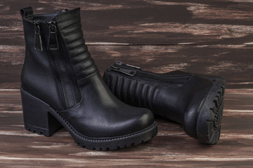 pair of leather boots on wooden surface