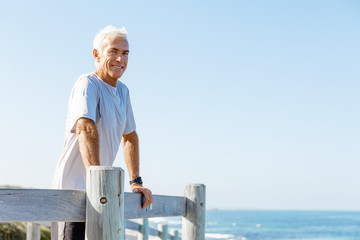 Fototapeta premium Man standing on beach in sports wear