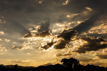 The sun sets behind the mountains