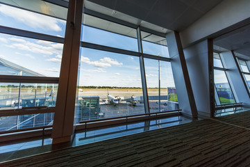 view from the window of a modern airport on the runway and the p
