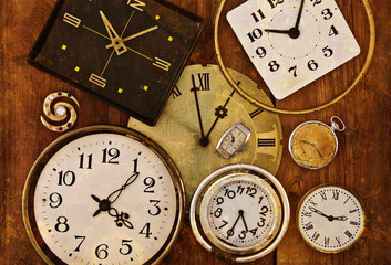 Old clock on a grungy background. Collection of vintage watches