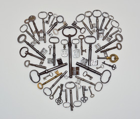 Heart Shape made from antique keys on white background.