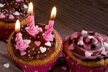 Delicious cupcakes with chocolate and sugar hearts