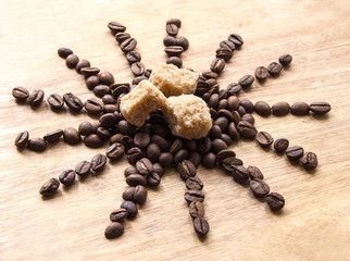 Coffee beans and sugar on a wooden board