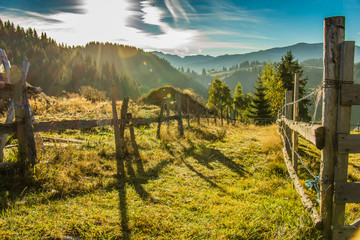 Fototapeta na wymiar Beautiful mountain and forest landscape with wooden fence