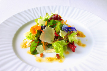 colorful salad with lettuce, parmesan cheese, flowers and raisins