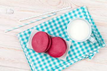 Obraz na płótnie Canvas Colorful macarons and cup of milk
