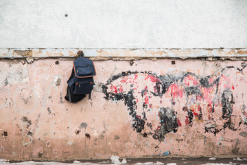 single schoolbag in rough area. 