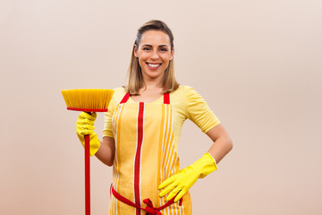 Portrait of beautiful housewife holding broom 