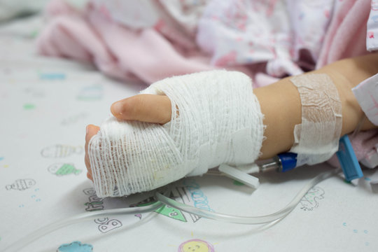 Closeup saline intravenous (IV) on hand baby
