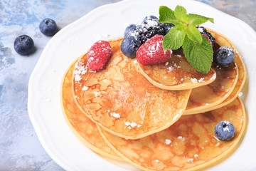 Pancakes with berries and mint