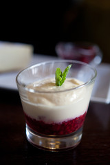 Close up photograph of a fancy panna cotta with strawberries