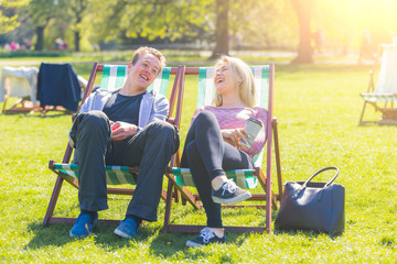 Young couple relaxing at park on a sunny day