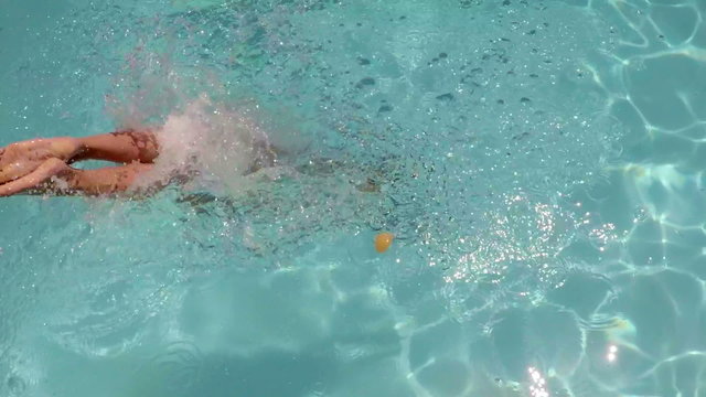 Sexy woman diving into the swimming pool