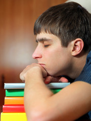 Young Man sleep on the Books