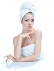 Pretty young girl enjoy a flawless skin, skin care concept / photo composition of blonde girl in towel - isolated on white background