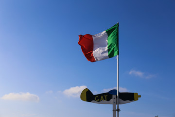 ITALIAN FLAG WAVING ON BLUE SKY