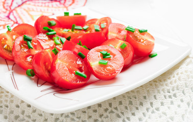 Cherry tomatoes decorated with green onions.