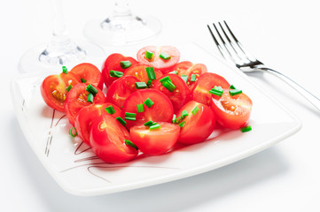 Cherry tomatoes decorated with green onions.