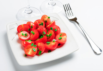 Cherry tomatoes decorated with green onions.