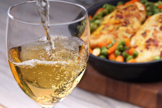 Pouring white wine and food