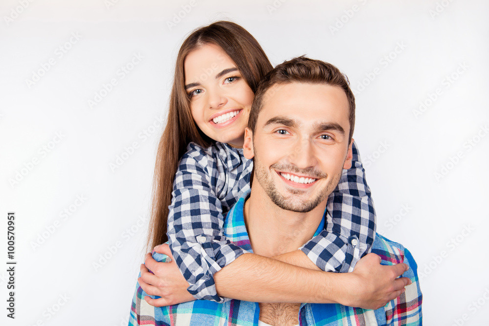 Poster pretty young woman embracing her boyfriend