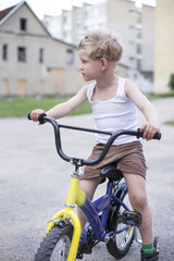 Child on a bicycle at asphalt road. Childhood. Sport. Cycling